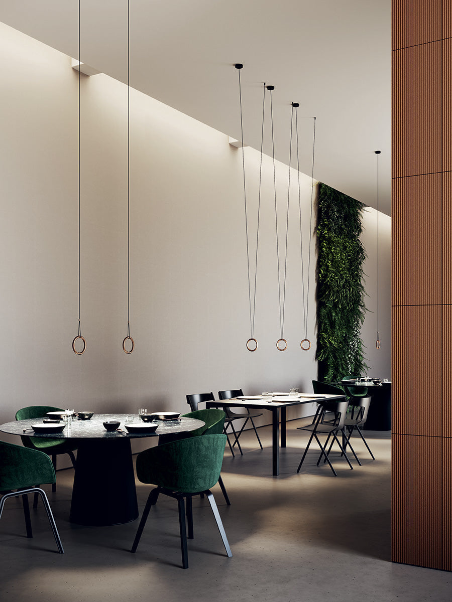 Lodes Ivy pendants over dining tables with a very high ceiling