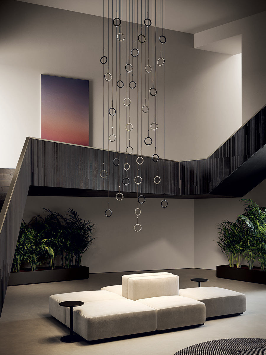 Lodes Ivy pendant in a large cluster formation over a modern white sofa