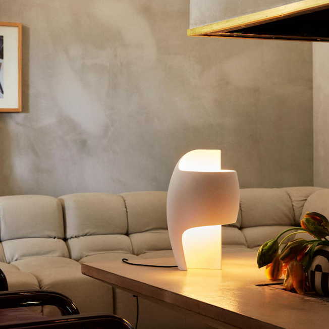 DCW Editions Lamp B table lamp on coffee table with white leather sofa
