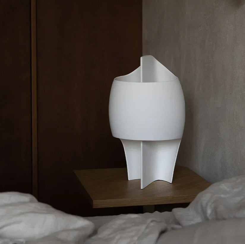 DCW Editions Lamp B table lamp on bedside table with wooden wardrobe in the background