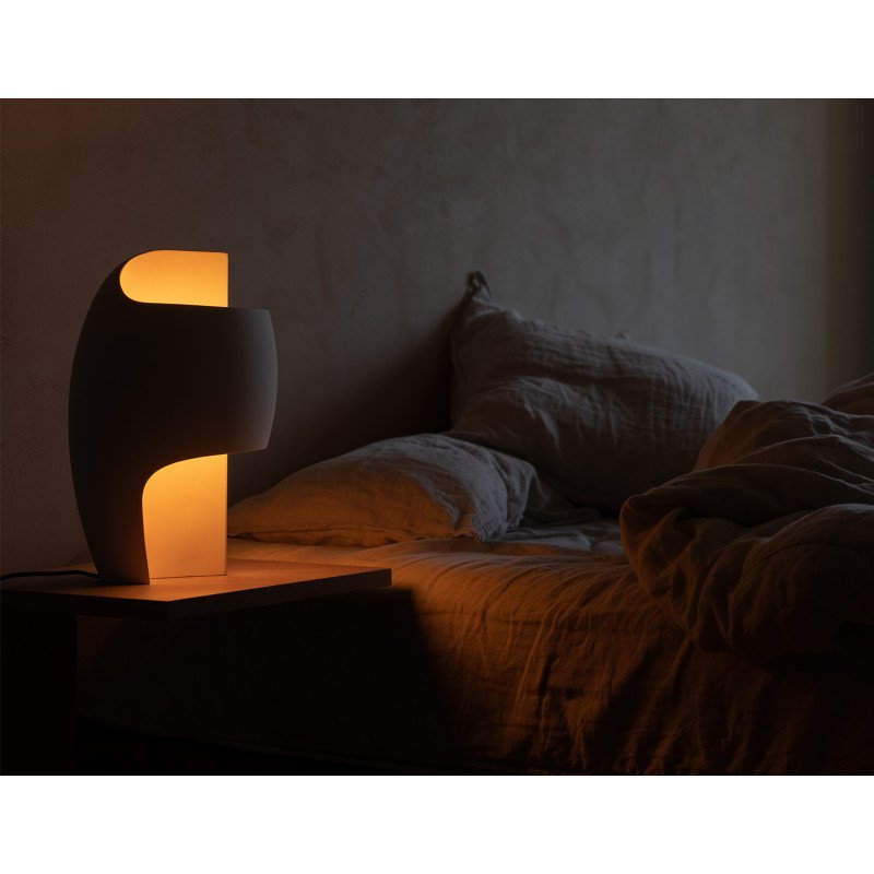 DCW Editions Lamp B table lamp on bedside table with rumbled bedding
