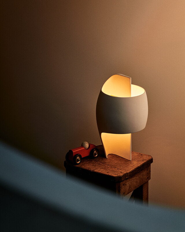 DCW Editions Lamp B table lamp on a small wooden side table with toy car