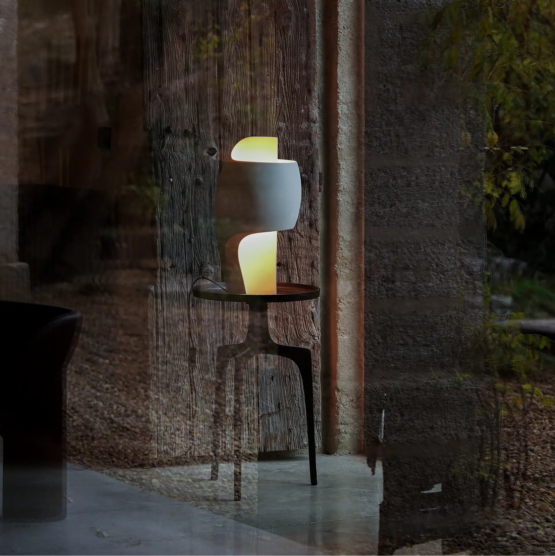 DCW Editions LampeB Grande table lamp on round side table by doorway