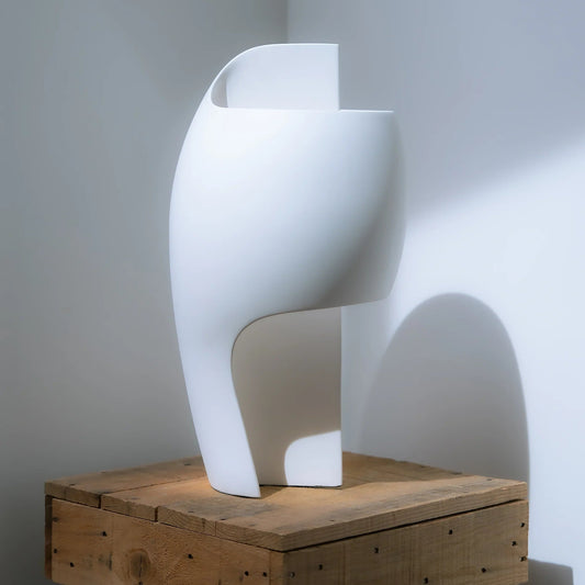 DCW Editions LampeB Grande table lamp unlit on wooden table with white walls