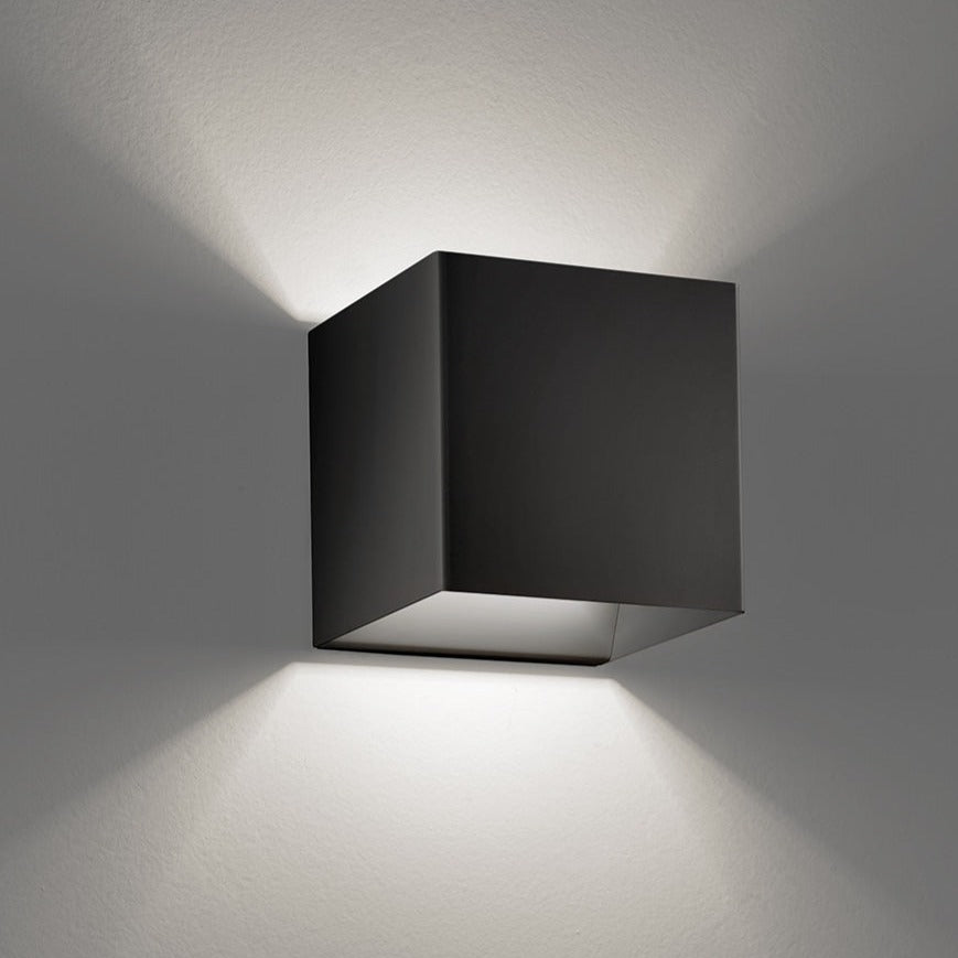 Black square wall light fixture on a gray wall