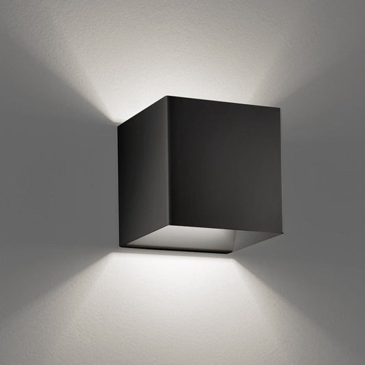 Black square wall light fixture on a gray wall