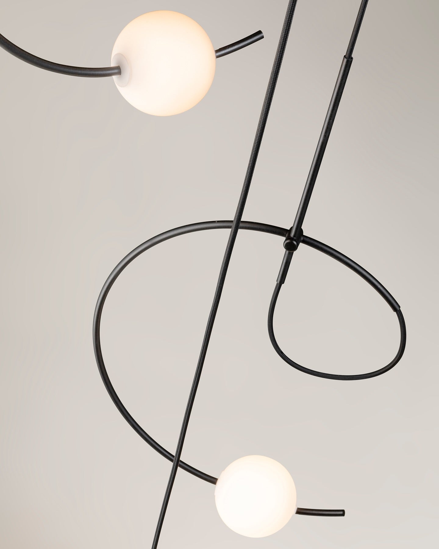 Estiluz Loop Pendant with black finish and two globes on grey background