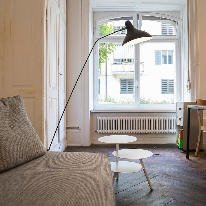 DCW Editions Mantis floor lamp BS1 next to a linen sofa with a triple side table