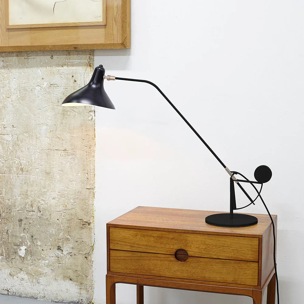 DCW Editions Mantis table lamp on small, wooden side table