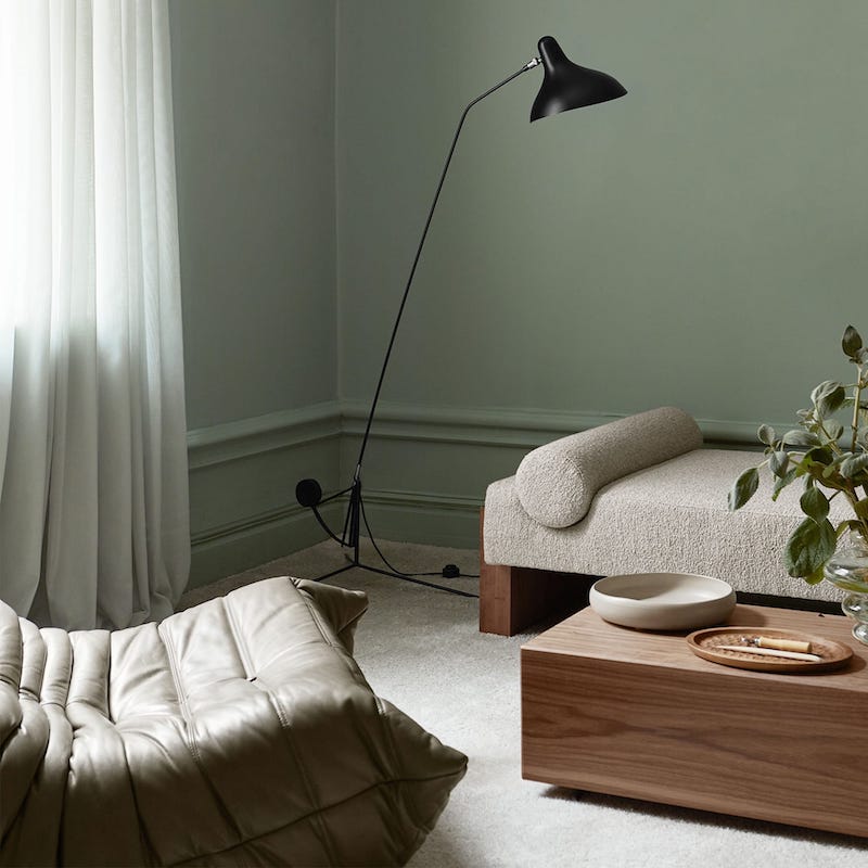 DCW Editions Mantis floor lamp BS1 in a green room with neutral coloured furniture