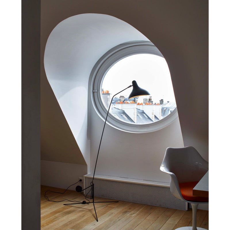 DCW Editions Mantis floor lamp BS1 in front of a large round window