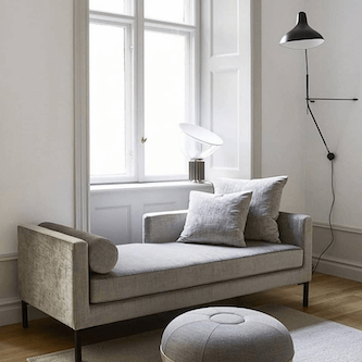 DCW Editions Mantis plug-in wall light BS2 above grey chaise lounge and poof