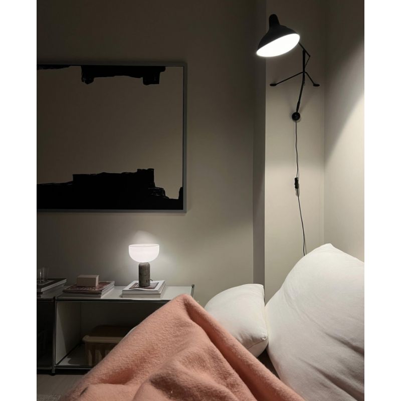 DCW Editions Mantis plug-in wall light BS2 above bed with table lamp nearby