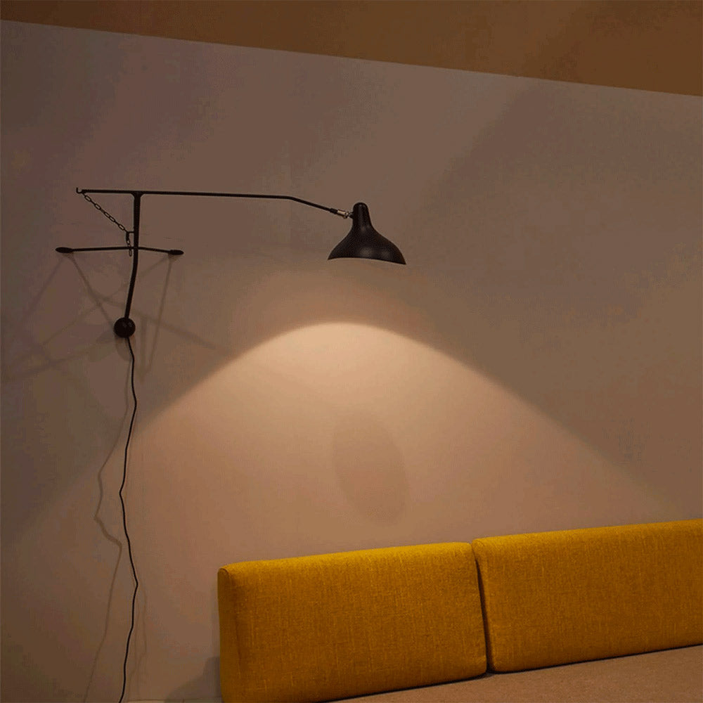 DCW Editions Mantis plug-in wall light BS2 above orange sofa in a room with an orange ceiling