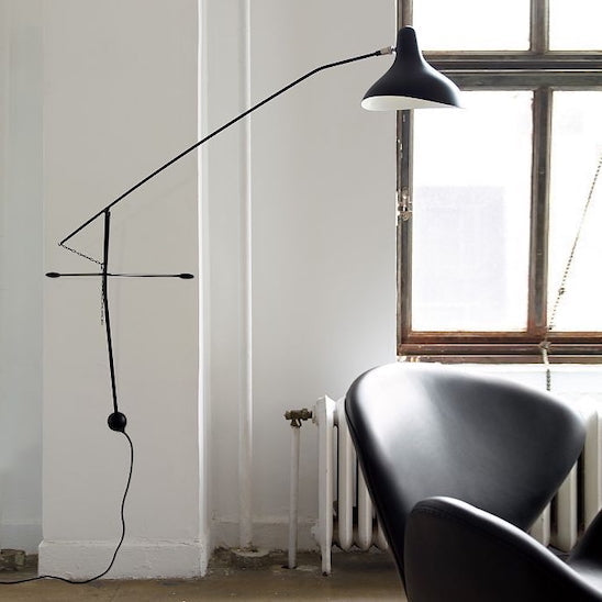 DCW Editions Mantis plug-in wall light BS2 above modern, black leather chair