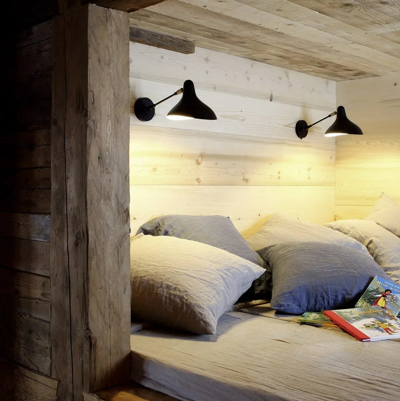 DCW Editions Mantis wall light standard BS5 with thumbswitch on wooden wall above reading nook with cushions and children's books