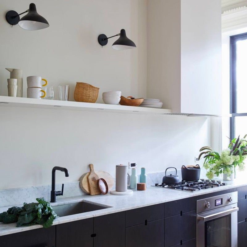 DCW Editions Mantis wall light BS5 with thumbswitch over kitchen with shelf holding crockery