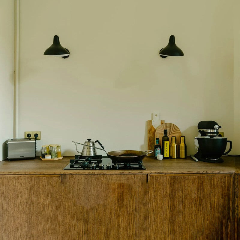 DCW Editions Mantis wall light standard BS5 with thumbswitch over small rustic kitchen with hob, mixer, pan and toaster
