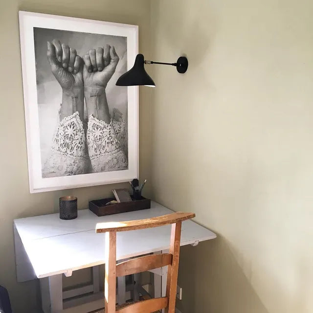 DCW Editions Mantis wall light standard BS5 with thumbswitch over small desk with print of two hands 