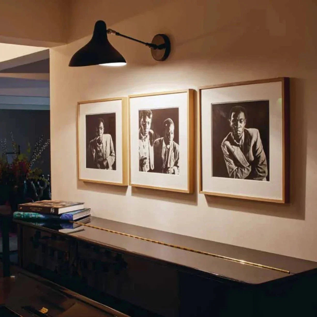DCW Editions Mantis wall light BS5 over piano with framed photographs of jazz musicians