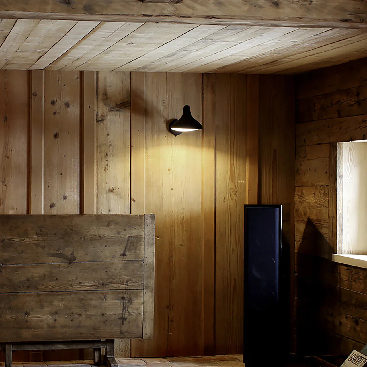 DCW Editions Mantis wall light standard BS5 with thumbswitch on wooden wall with a wooden collapsable table and window