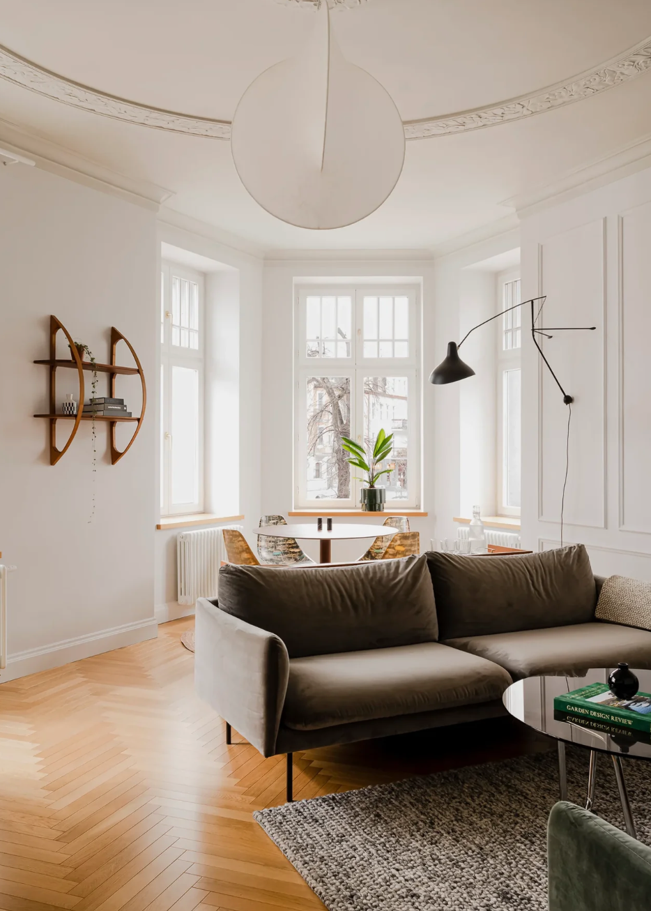 DCW Editions Mantis extending wall light in modern, open plan lounge with dining table