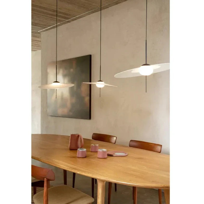 DCW Editions Mono pendant over long, wooden oval dining table