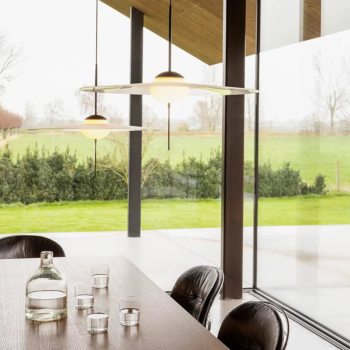 DCW Editions Mono pendant over dining table with glass all around