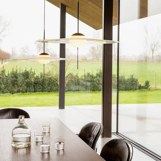 DCW Editions Mono pendant over dining table with glass all around