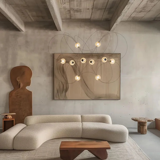 DCW Editions Munari pendant with 10 acrylic spheres on curved rods in modern lounge with curved sofa