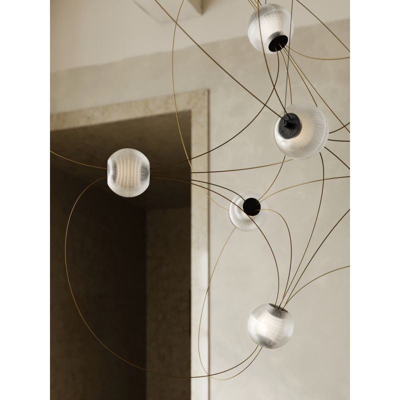 DCW Editions Munari pendant with acrylic spheres and gold curved rods close up by doorway
