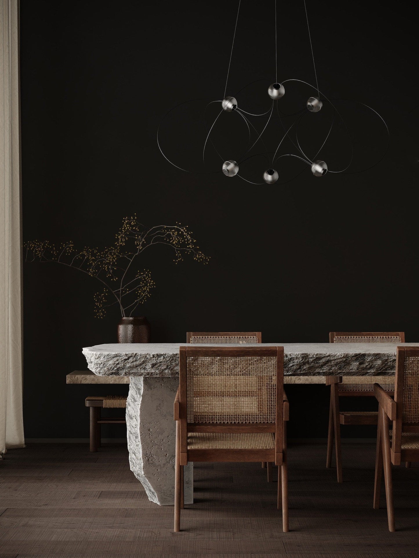 DCW Editions Munari pendant with 6 acrylic spheres and black curved rods unlit over stone table with wooden chairs and dark walls