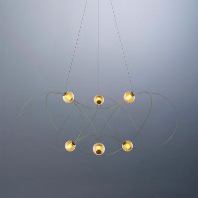 DCW Editions Munari pendant with gold, curved rods and 6 acrylic spheres with warm light on blue background