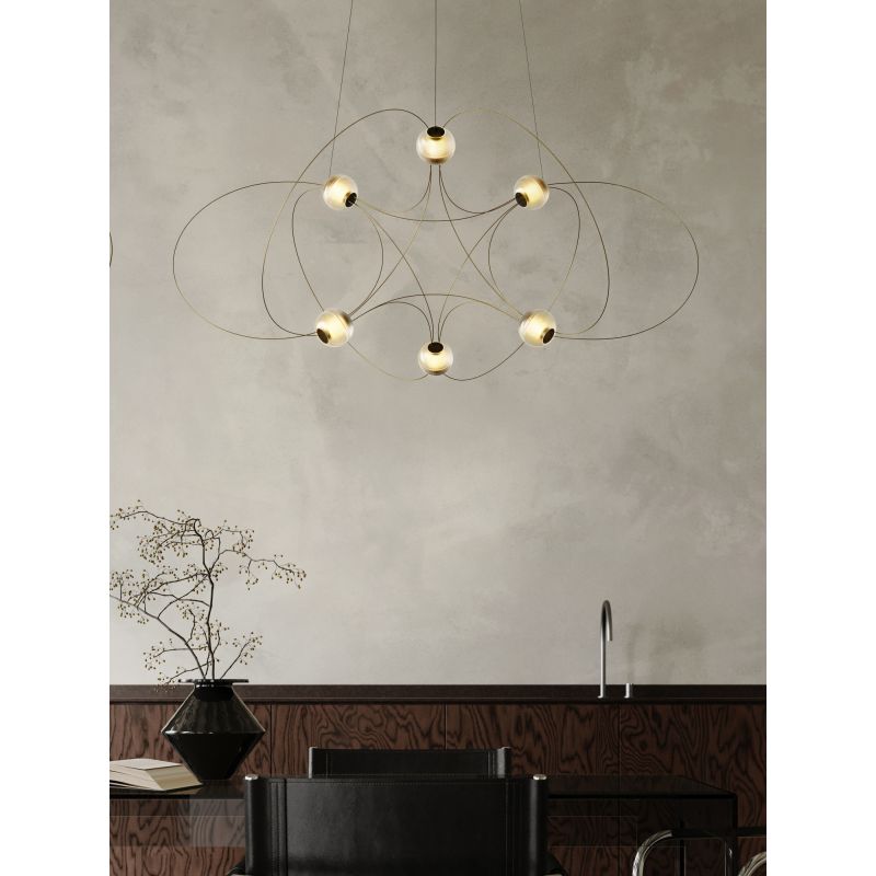 DCW Editions Munari pendant with 6 acrylic spheres and gold curved rods over dining table with sink against the wall