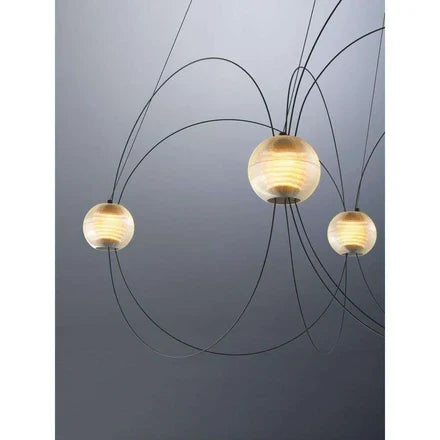 DCW Editions Munari pendant with black, curved rods and acrylic spheres with warm light on blue background
