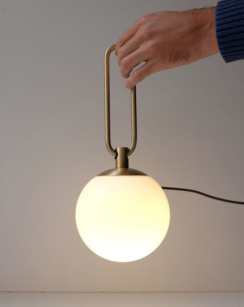 Nihm-Wall-or-Table-Lamp-Being-Carried