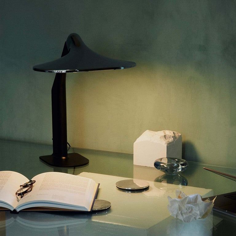 DCW Editions Niwaki black and chrome desk light on glass table with book and other objects