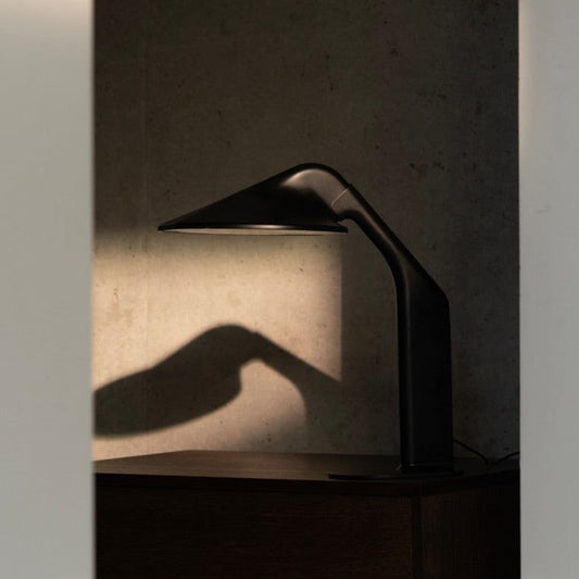 DCW Editions Niwaki black desk light on table with shadow of the light on the wall