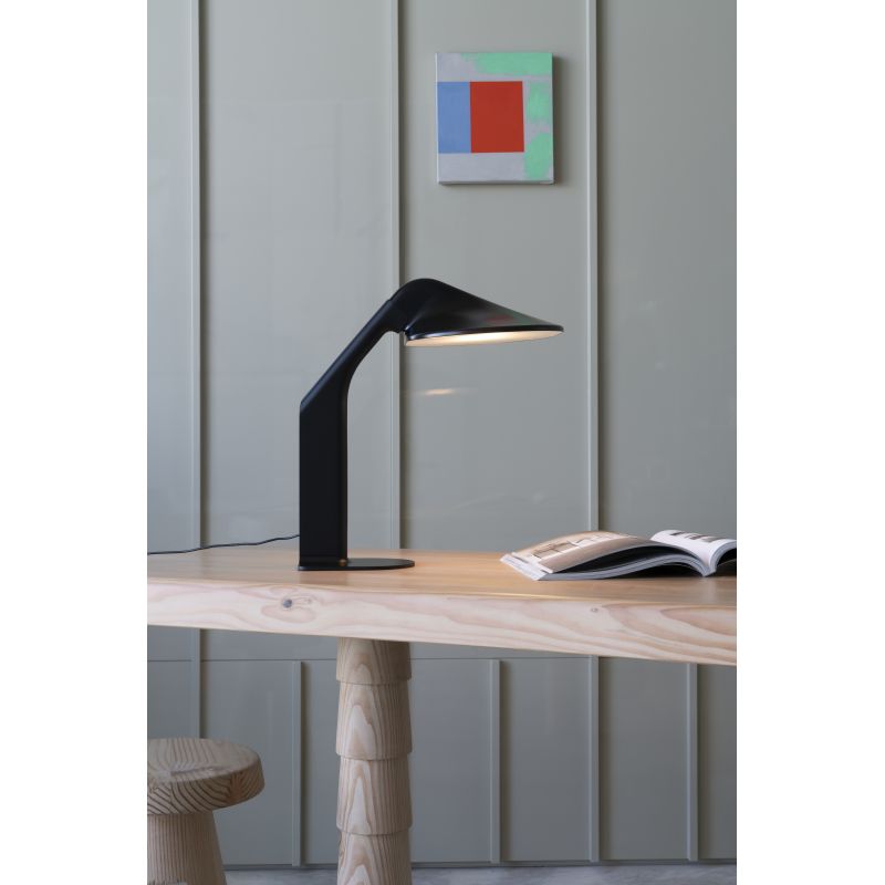 DCW Editions Niwaki black desk light on wooden table with book and modern art on the wall