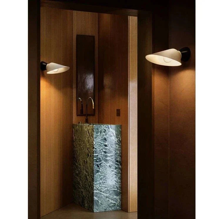 DCW Editions Plume Wall Light in wooden powder room with marble sink