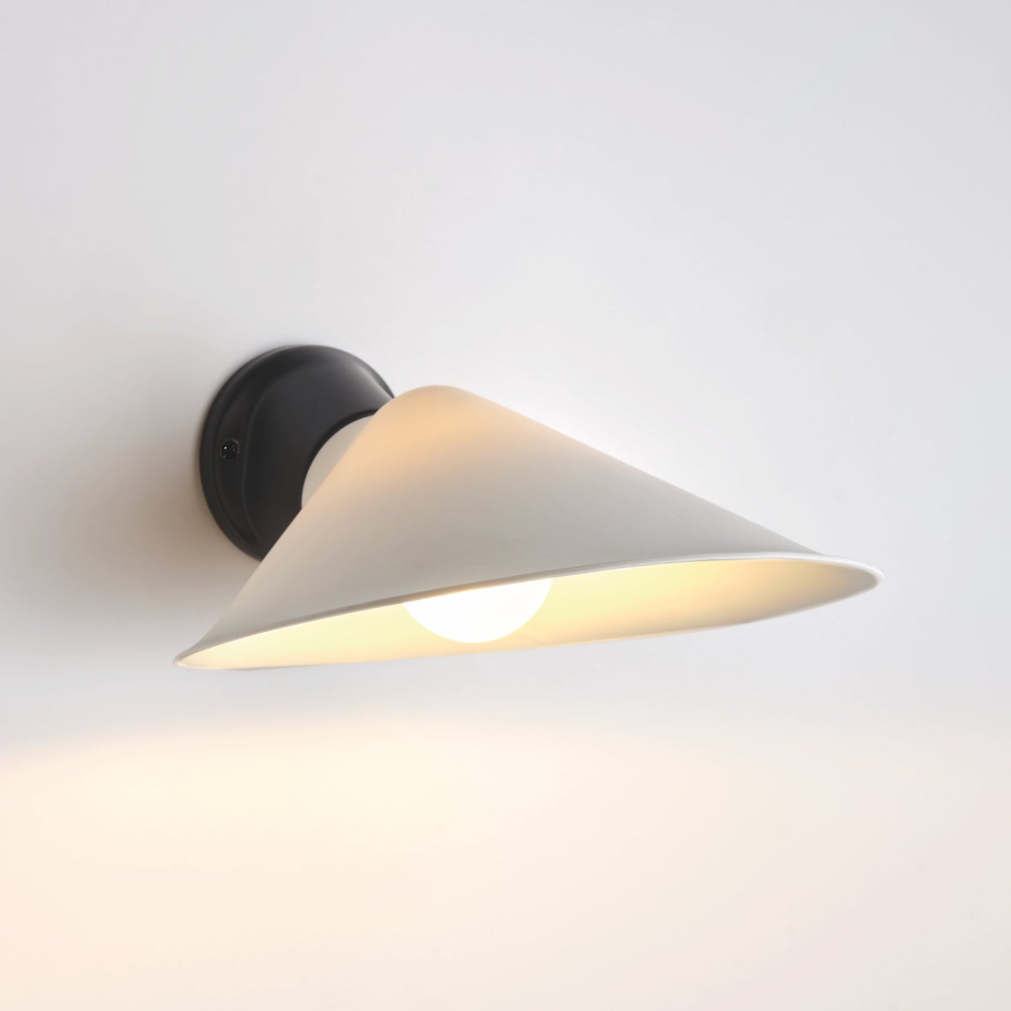 DCW Editions Plume wall light with polycarbonate shade and black base with white background