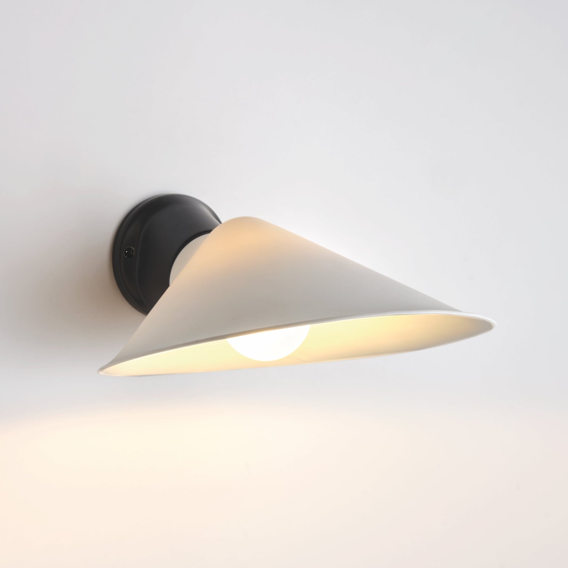 DCW Editions Plume wall light with polycarbonate shade and black base with white background