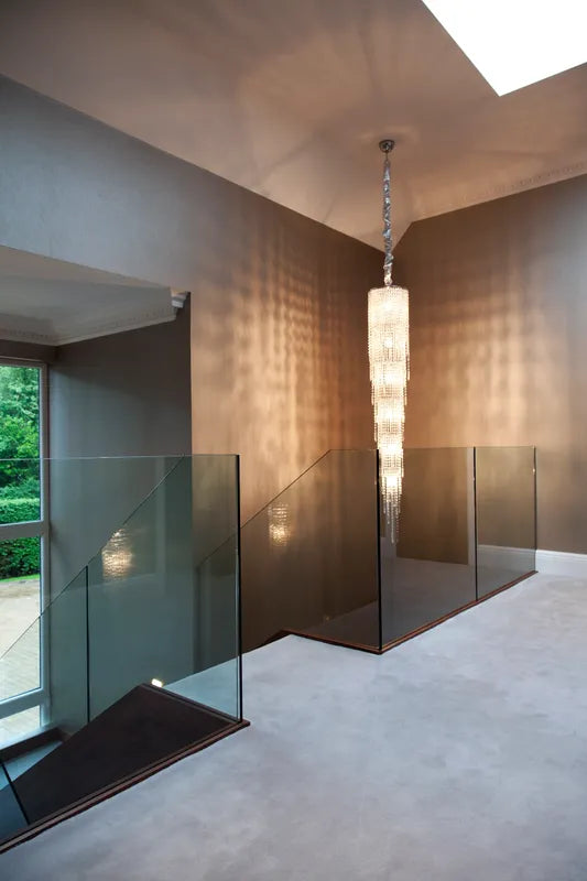 Cascading crystal chandelier in modern staircase