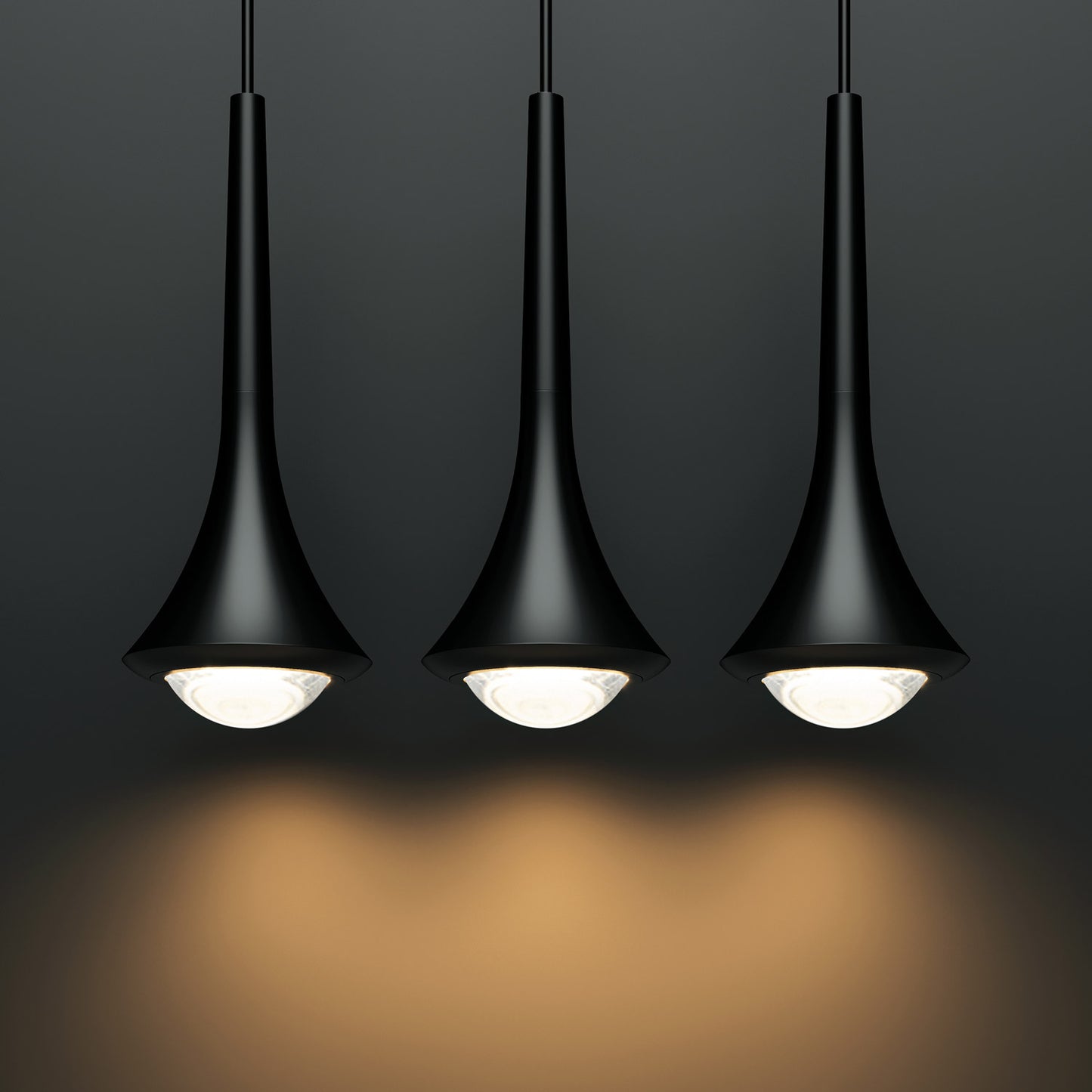 Lodes Rain pendants in black hung in a row with warm light on a dark background