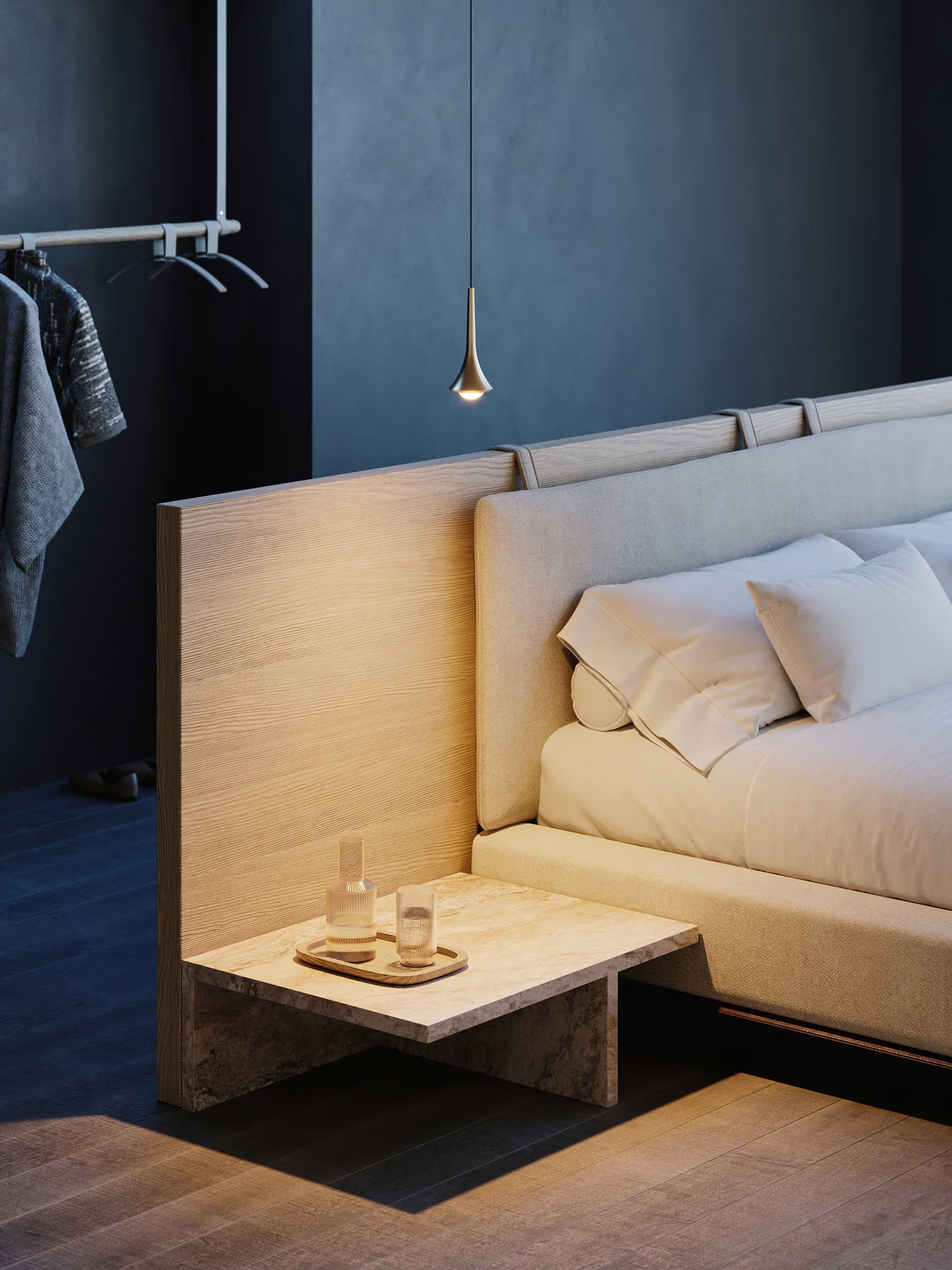 Lodes Rain pendant in champagne hung by a bed with with a low wooden bedside table