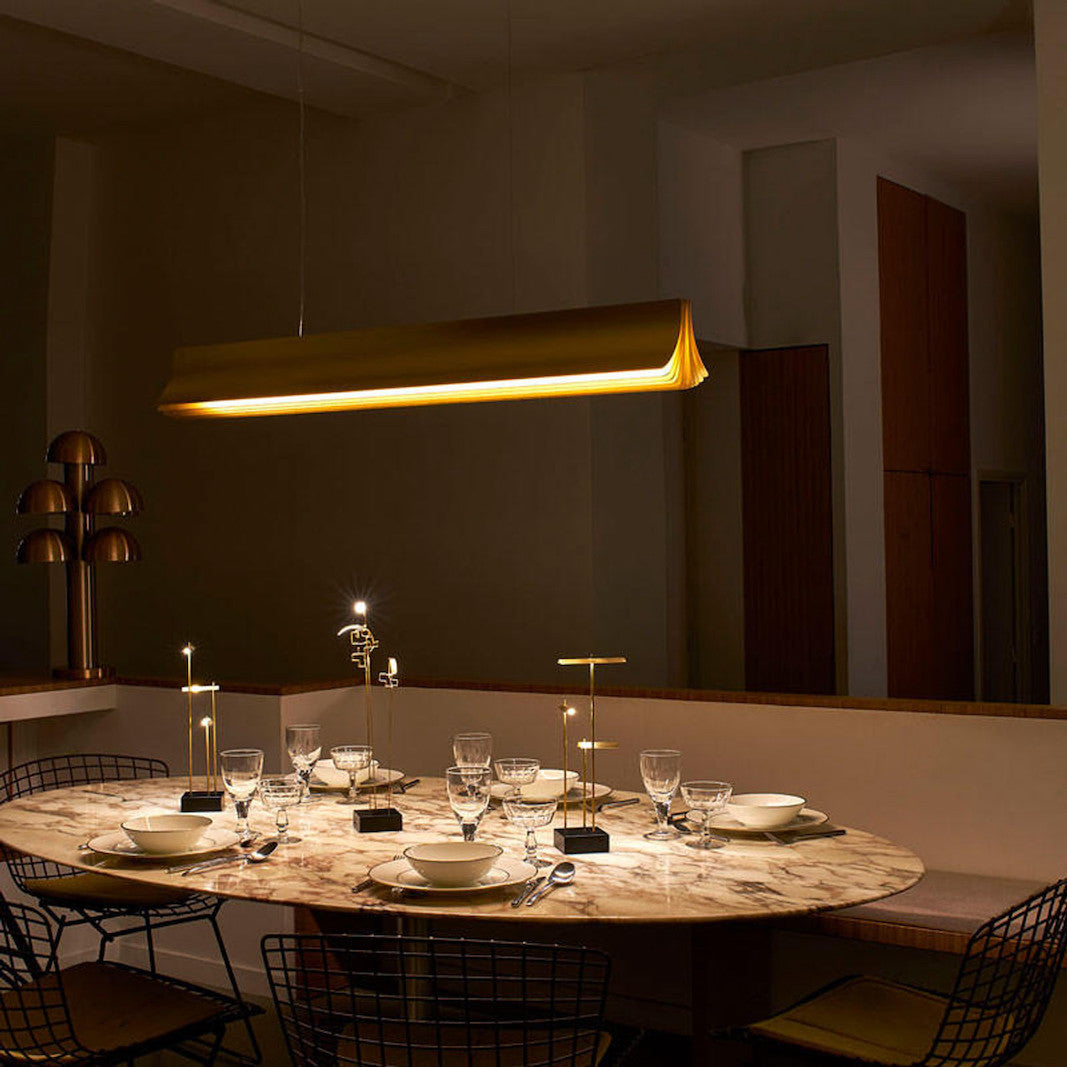 DCW Editions Respiro gold 1200mm linear pendant over dining table with wireless lights and place settings