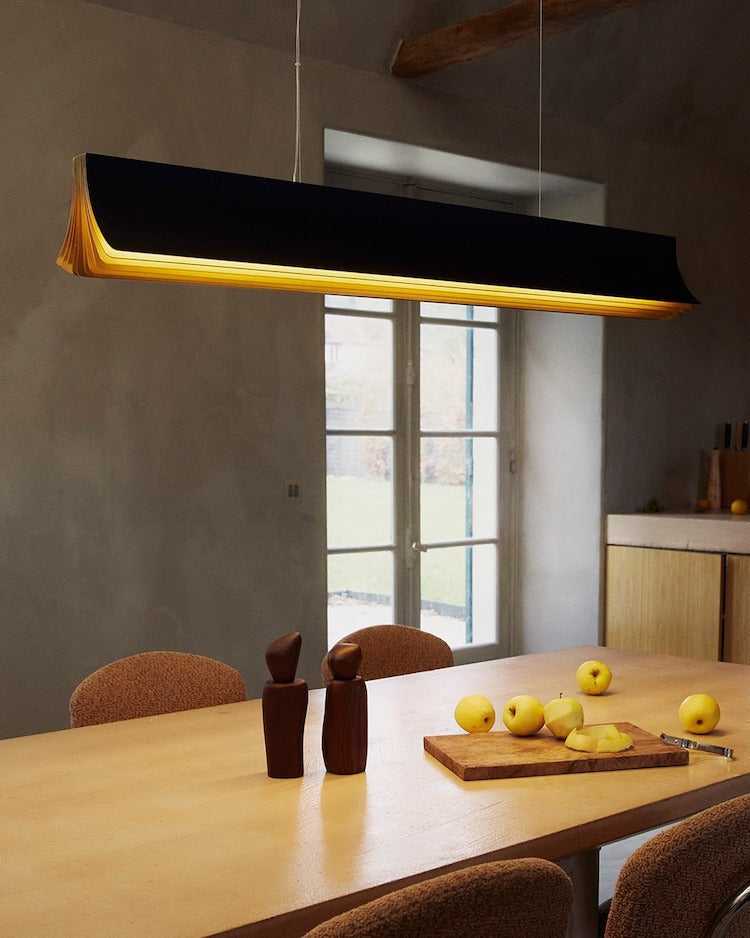 DCW Editions Respiro black and gold 1200mm linear pendant over kitchen table with apples with beams in the ceiling