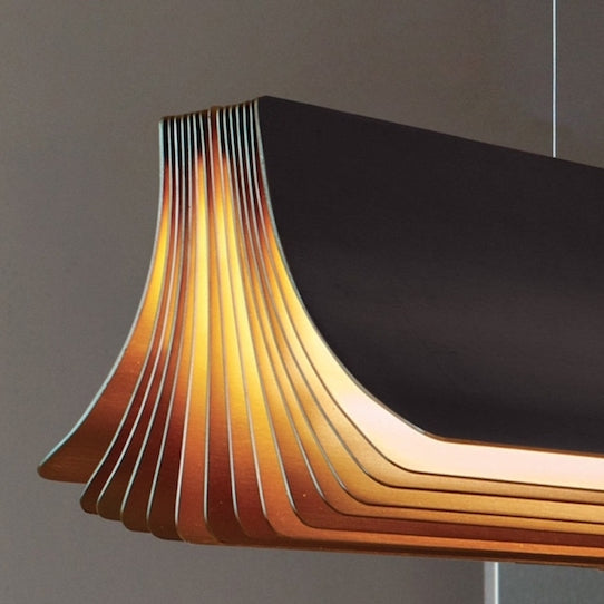 DCW Editions Respiro black and gold close up and illuminated with brown background