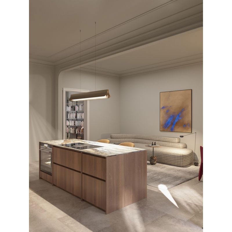 DCW Editions Respiro gold 1200mm linear pendant over kitchen island with modern lounge in the background