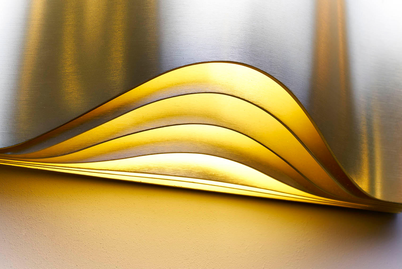 DCW Editions Respiro brass wall light with curved brass metal